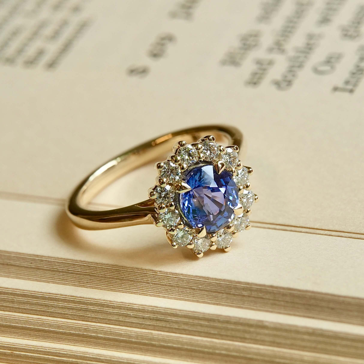 Oval-cut blue sapphire and diamond cluster engagement ring