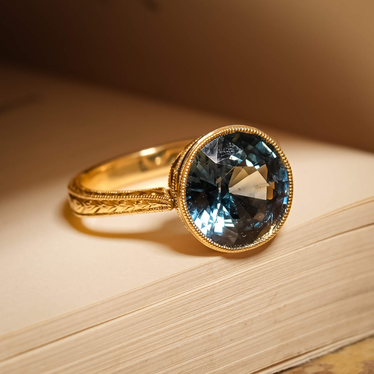 Caribbean blue green sapphire ring in solitaire setting with gold band
