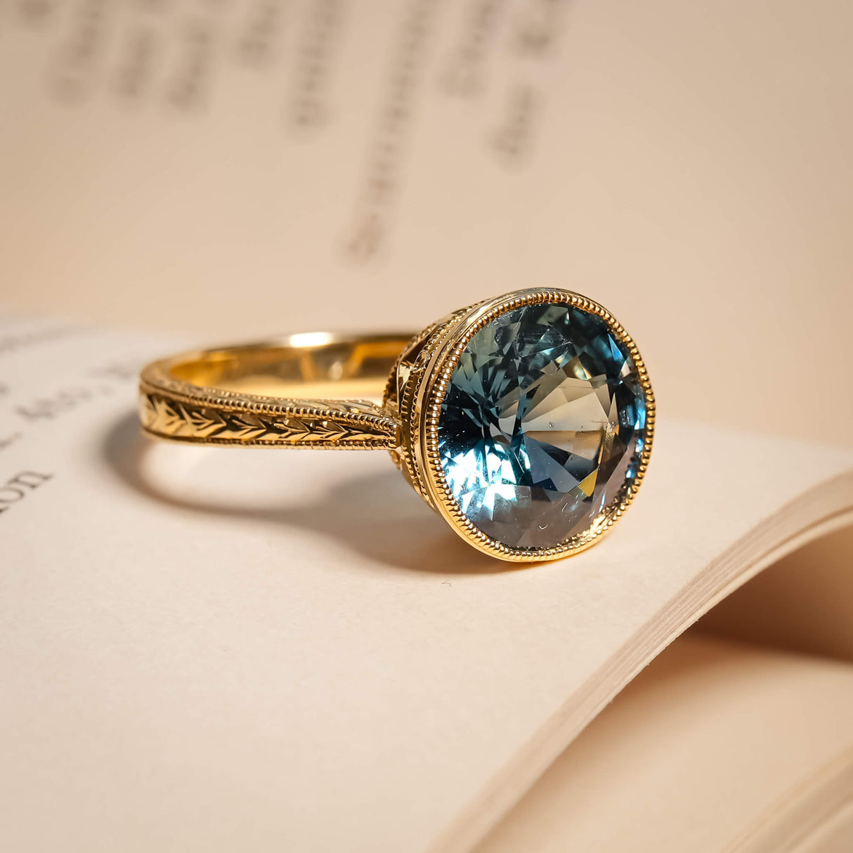 Caribbean sapphire solitaire ring with blue green gemstone in gold band