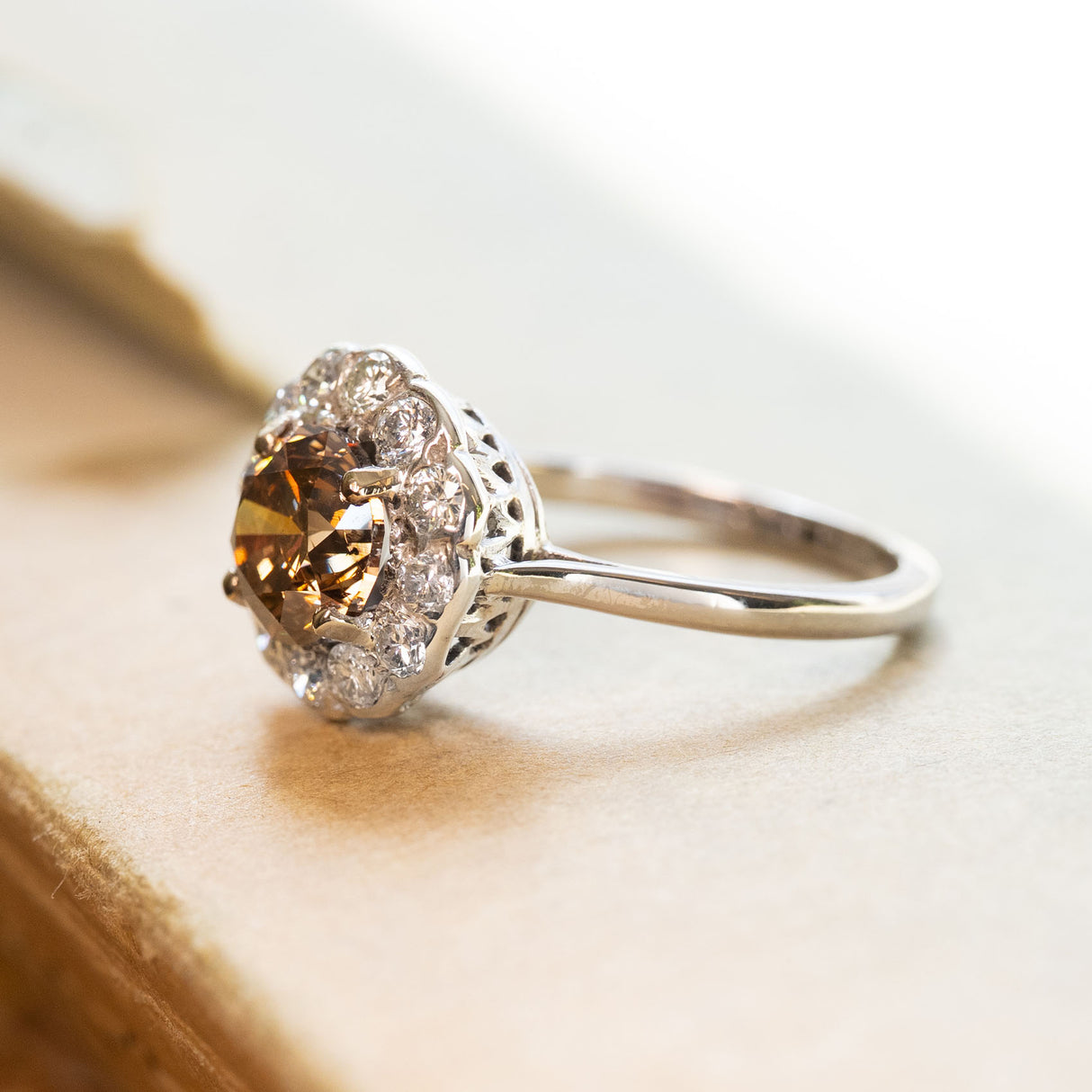 Vintage cinnamon brown diamond cluster ring with round brown diamond surrounded by brilliant-cut diamonds.