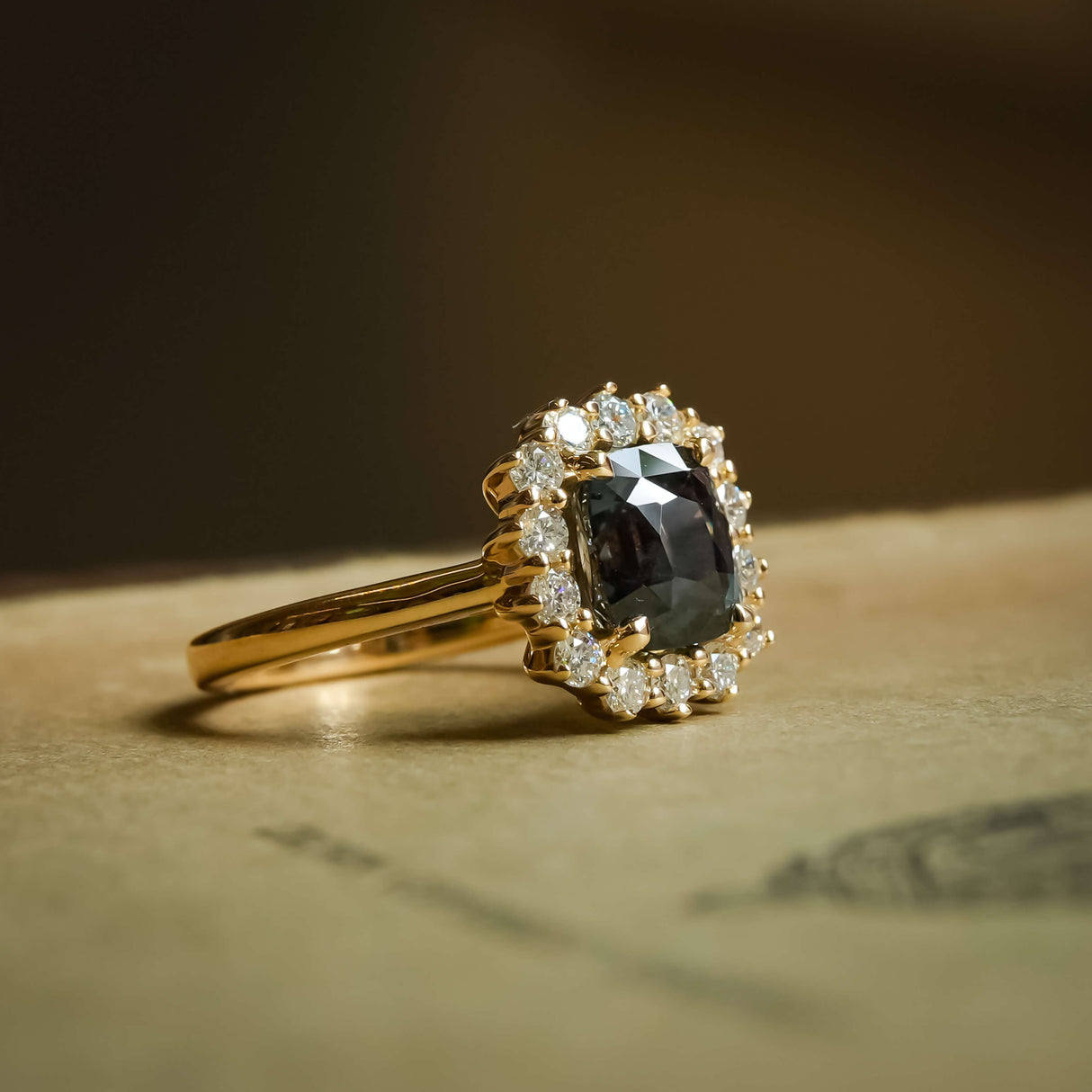 Cushion cut green sapphire with diamond cluster halo engagement ring in yellow gold