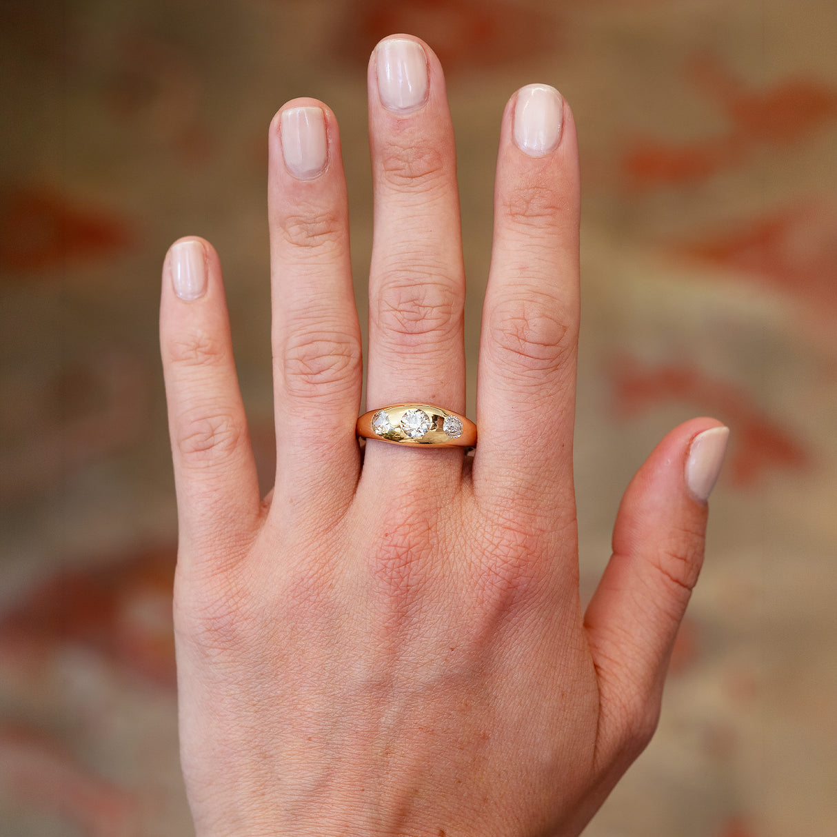 Edwardian diamond gypsy ring worn on hand with polished gold band