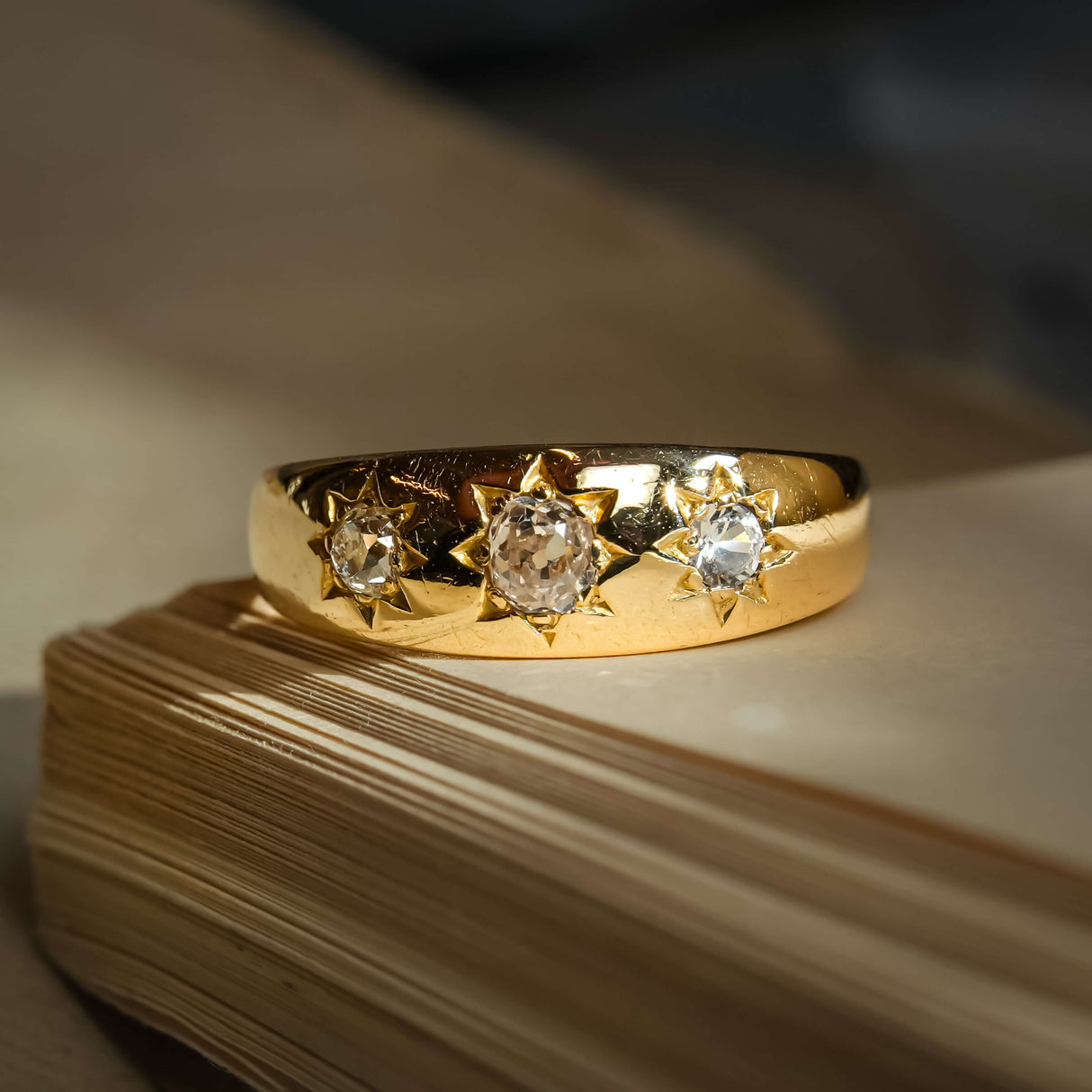 Edwardian gypsy ring with old mine cut diamonds and star set design in gold