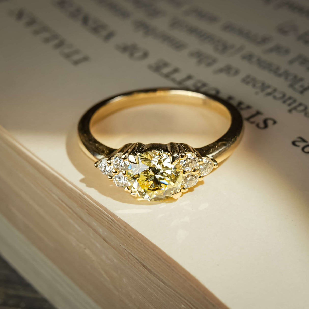Fancy light yellow diamond ring with trefoil cluster design and white diamond accents