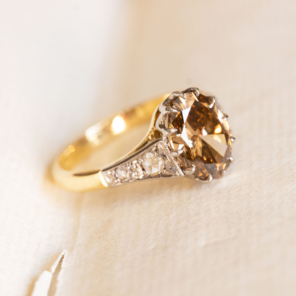 Antique-inspired hazelnut-brown diamond engagement ring with rose-cut diamond accents and yellow gold band.