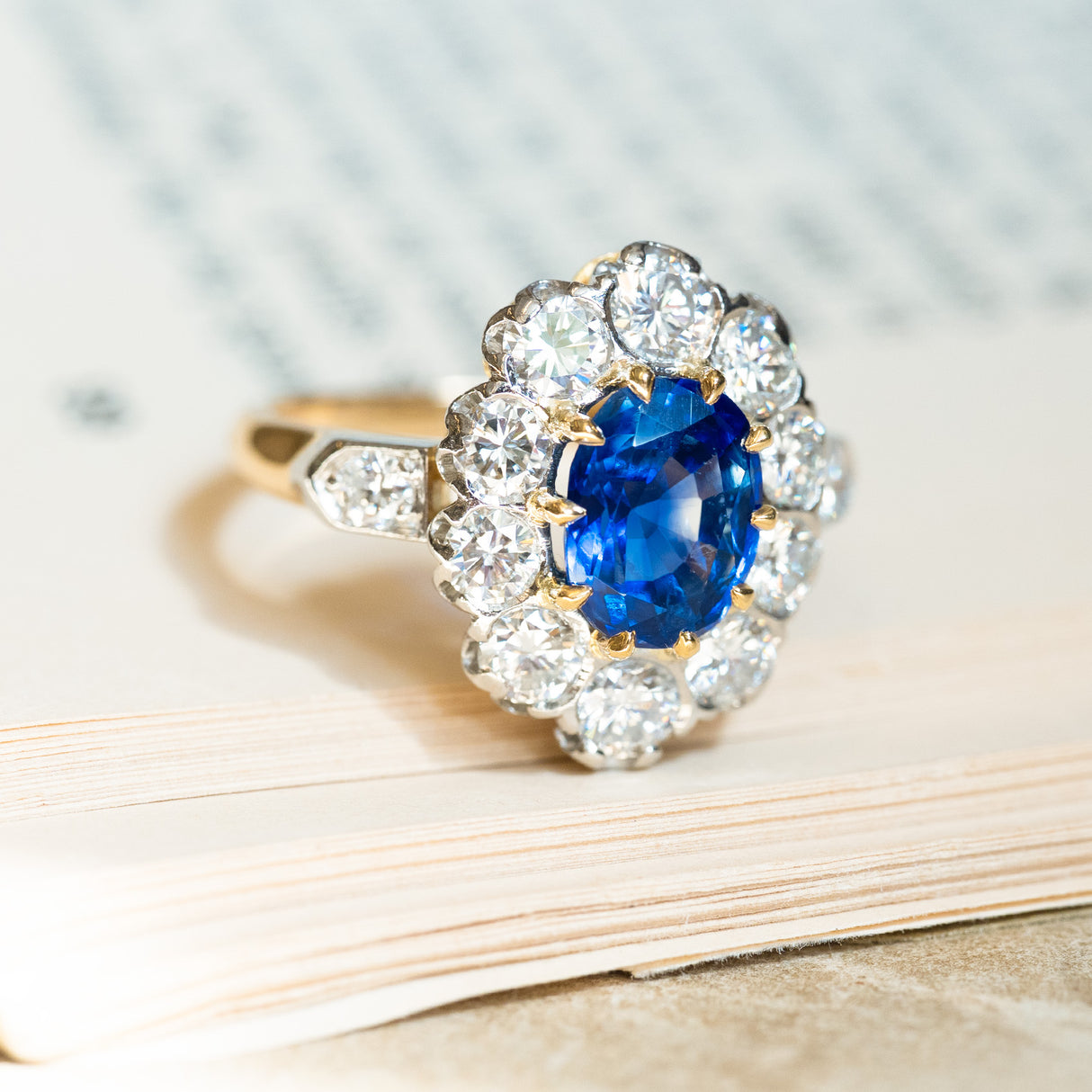 Vintage 1960s French sapphire and diamond cluster ring with oval sapphire centre surrounded by round brilliant diamonds.