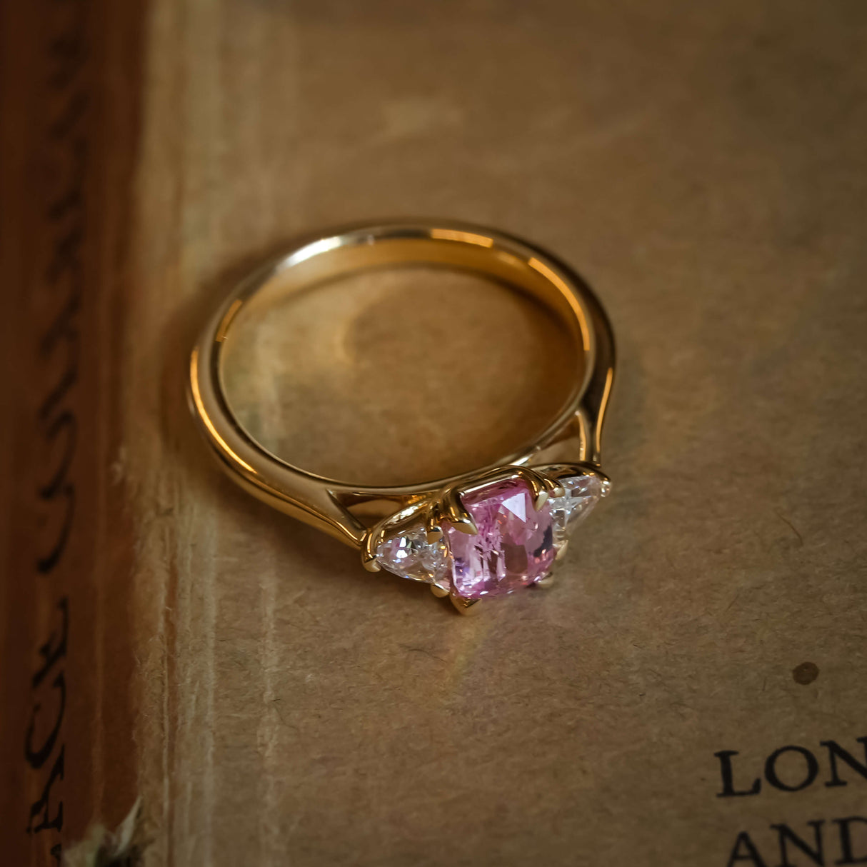 Padparadscha sapphire three stone diamond engagement ring with vintage style setting