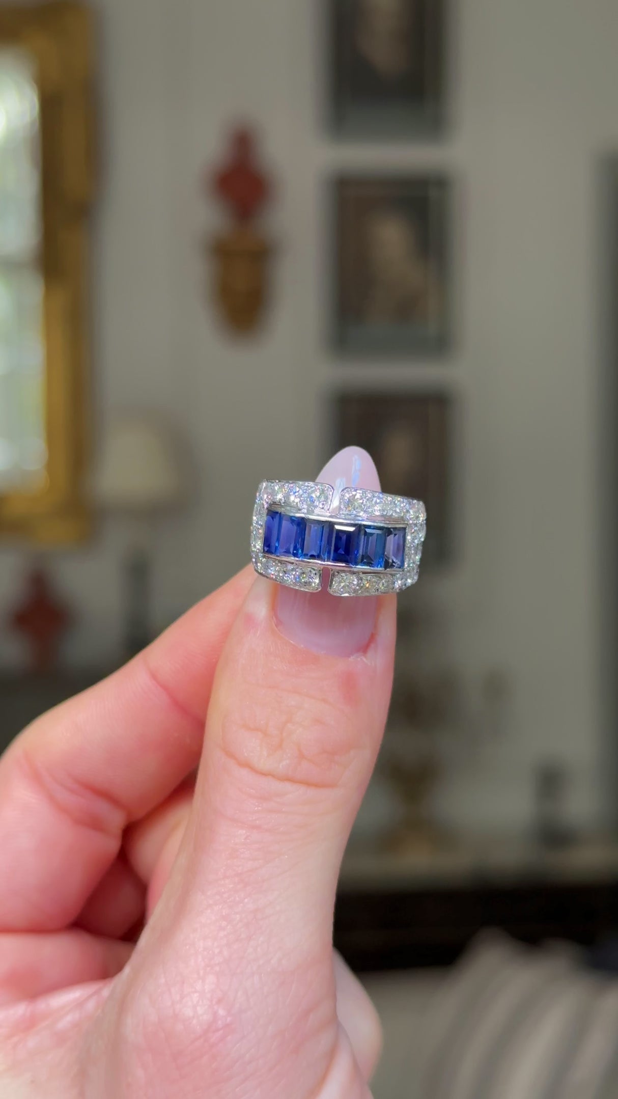 Sapphire and diamond Art Deco Band, held in fingers and rotated to give perspective