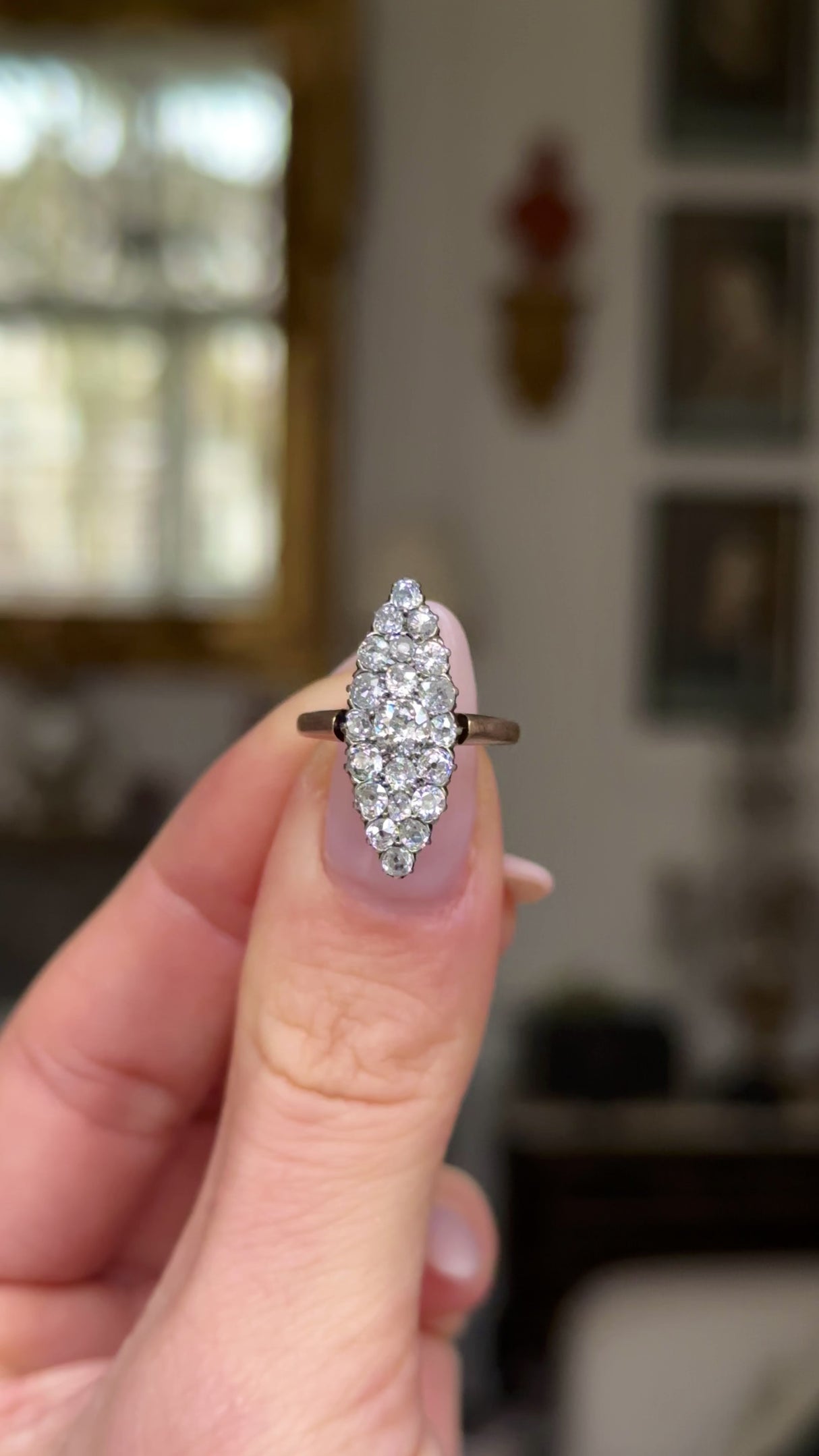 Antique diamond navette ring held in fingers and moved around to give perspective.