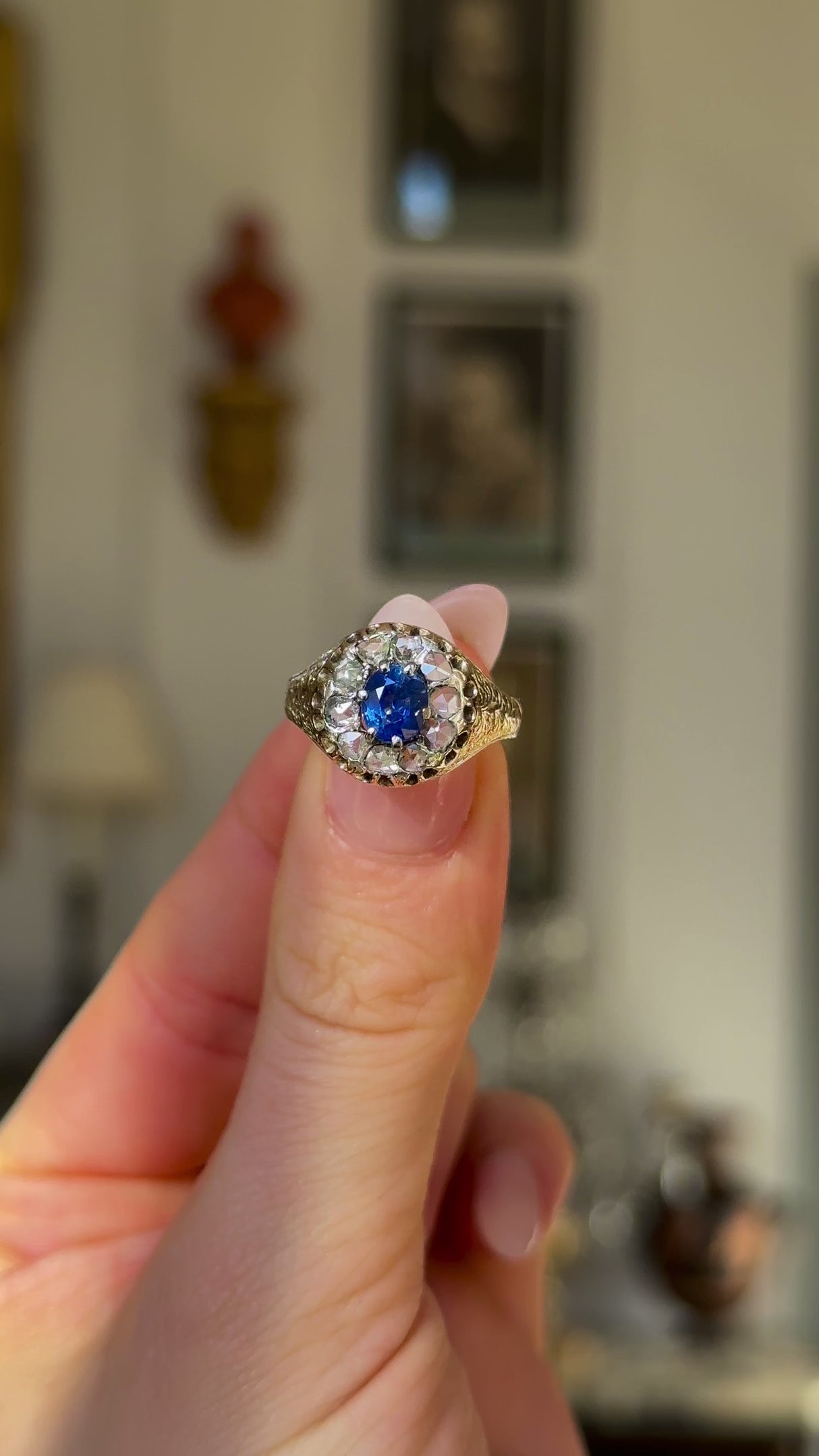 Antique, Victorian Sapphire and Diamond Daisy Cluster Ring, 18ct Yellow Gold held in fingers and rotated to give perspective.