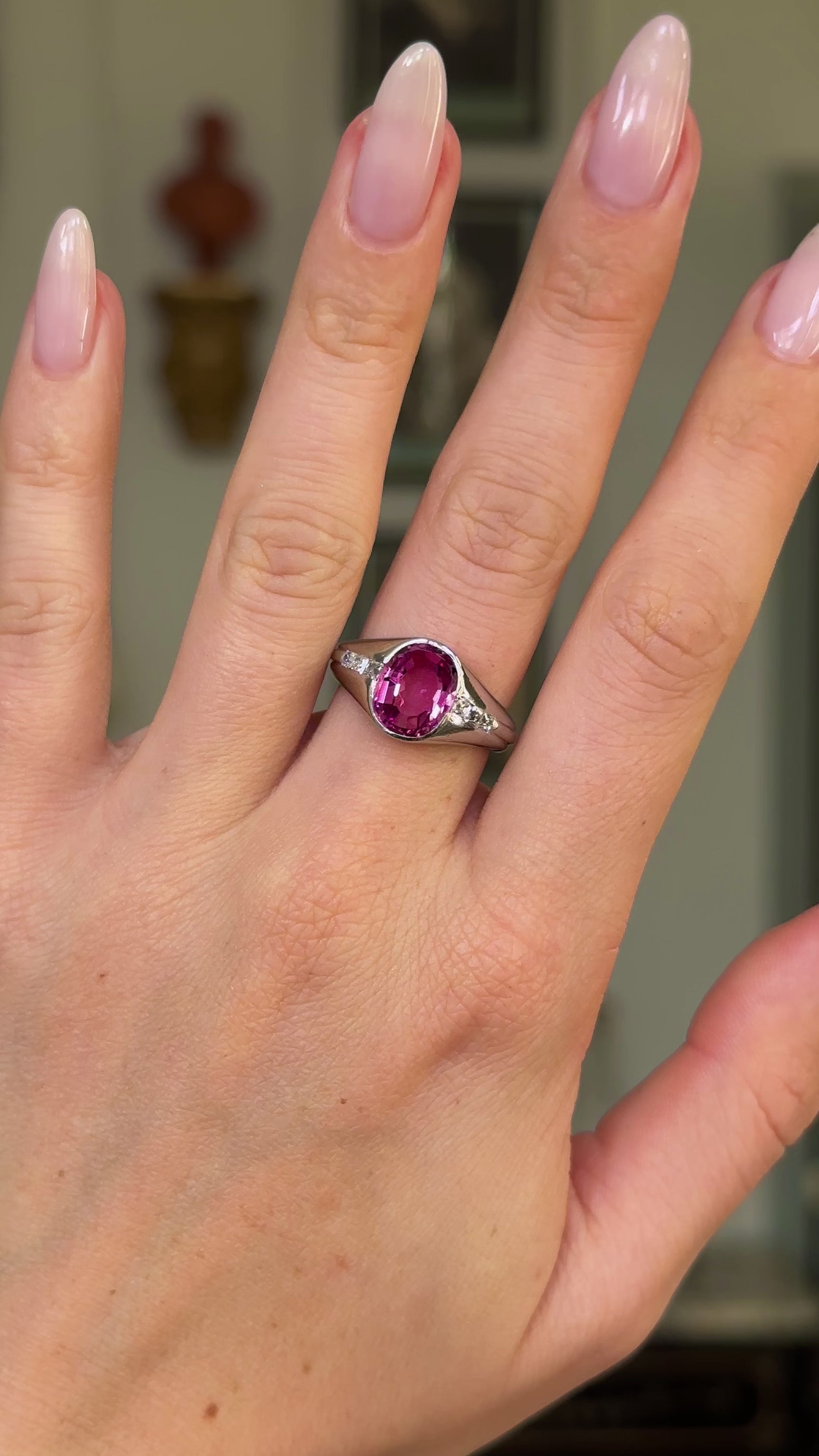 vintage pink sapphire, diamond and platinum ring worn on hand and moved around to give perspective.