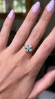 Art Deco emerald and diamond kite shaped ring, worn on hand and moved away from lens to give perspective,front view. 