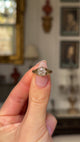 Antique solitaire diamond engagement ring held in fingers and rotated to give perspective.