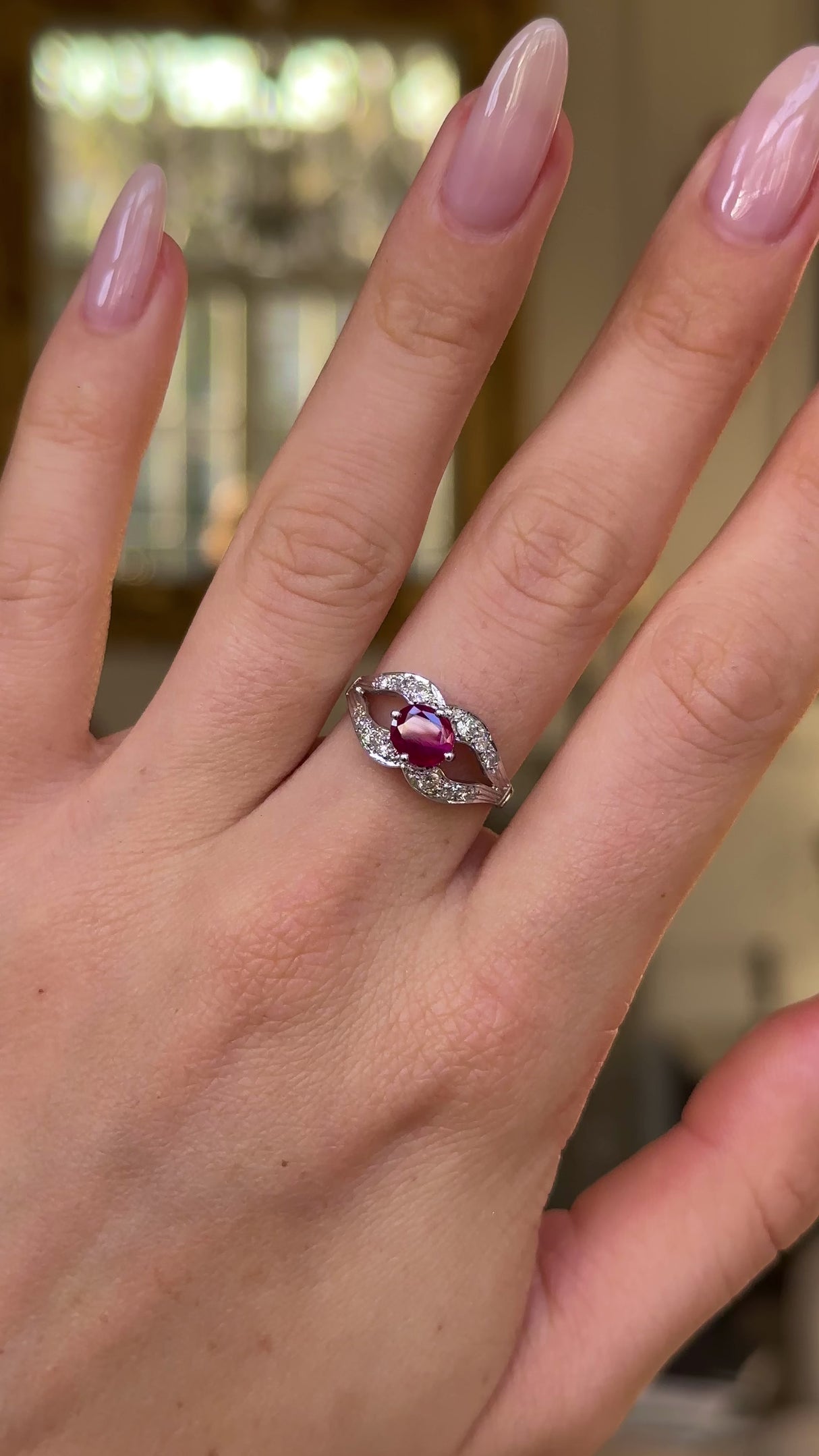 Vintage art deco ruby and diamond ring worn on hand and moved around to give perspective.