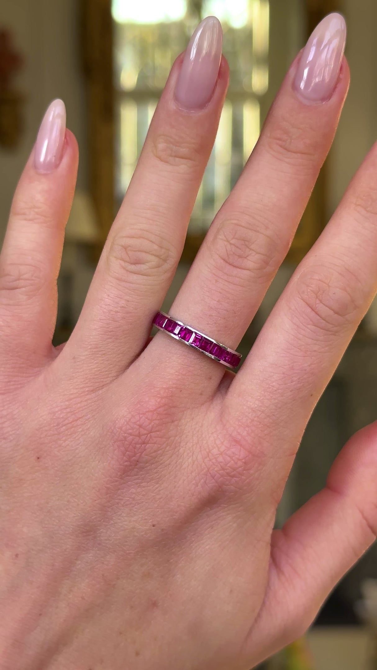 Vintage ruby eternity ring worn on hand and moved around to give perspective.