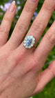 Vintage, 1980s cornflower blue sapphire & diamond cluster ring worn on hand.
