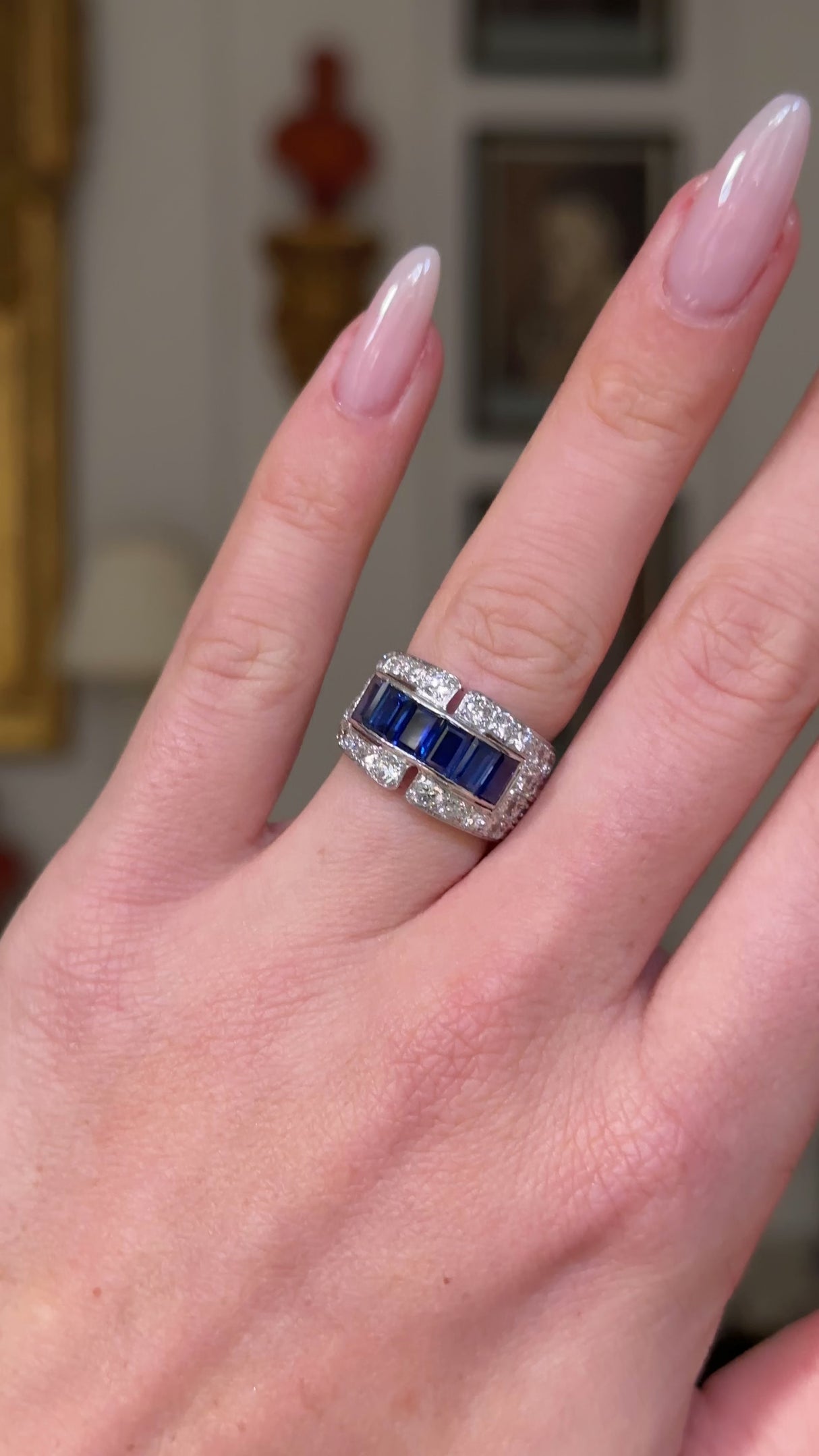 Sapphire and diamond Art Deco Band, worn on hand and moved away from lens to give perspective.