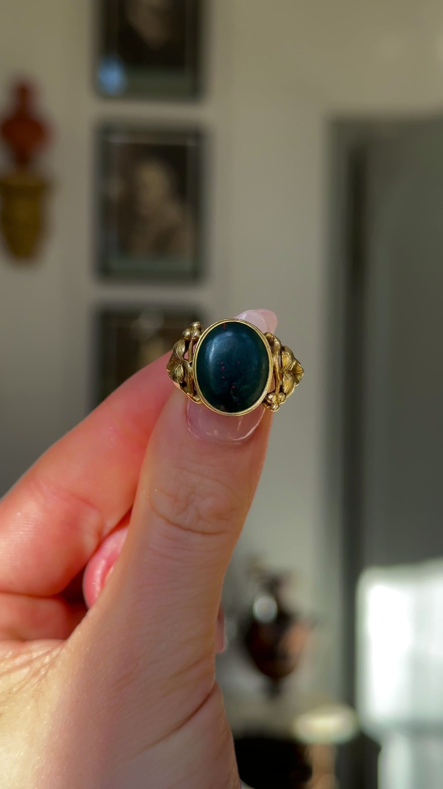 Antique, Victorian Bloodstone Signet Ring, 18ct Yellow Gold held in fingers and rotated to give perspective.