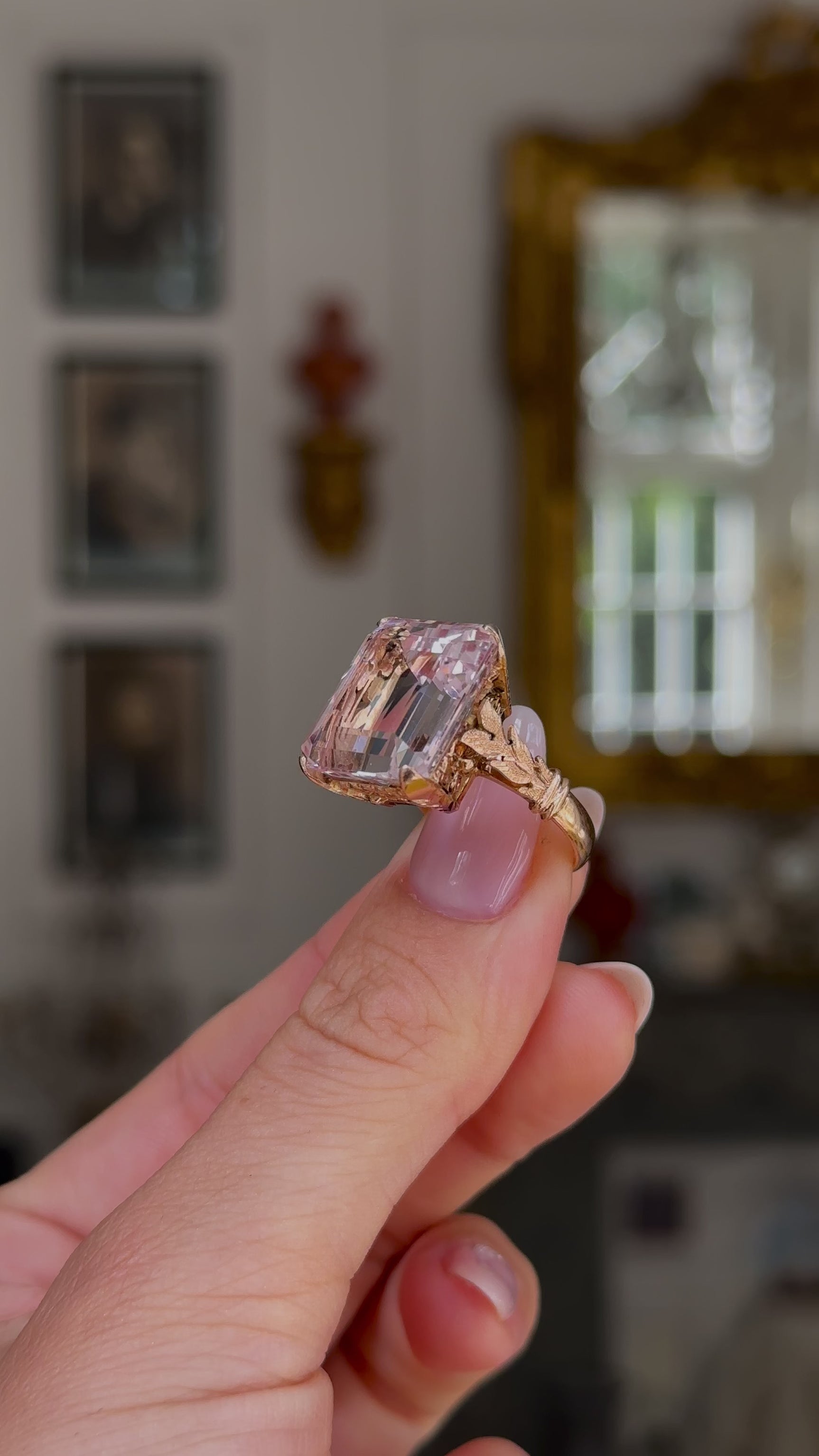 Morganite cocktail ring held in fingers and moved around to give perspective.