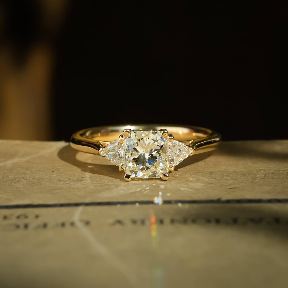 Round 1.07ct diamond with side diamonds three stone engagement ring in classic yellow gold