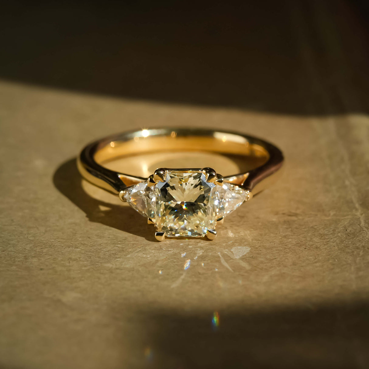 Round 1.07ct diamond with side diamonds three stone engagement ring in yellow gold