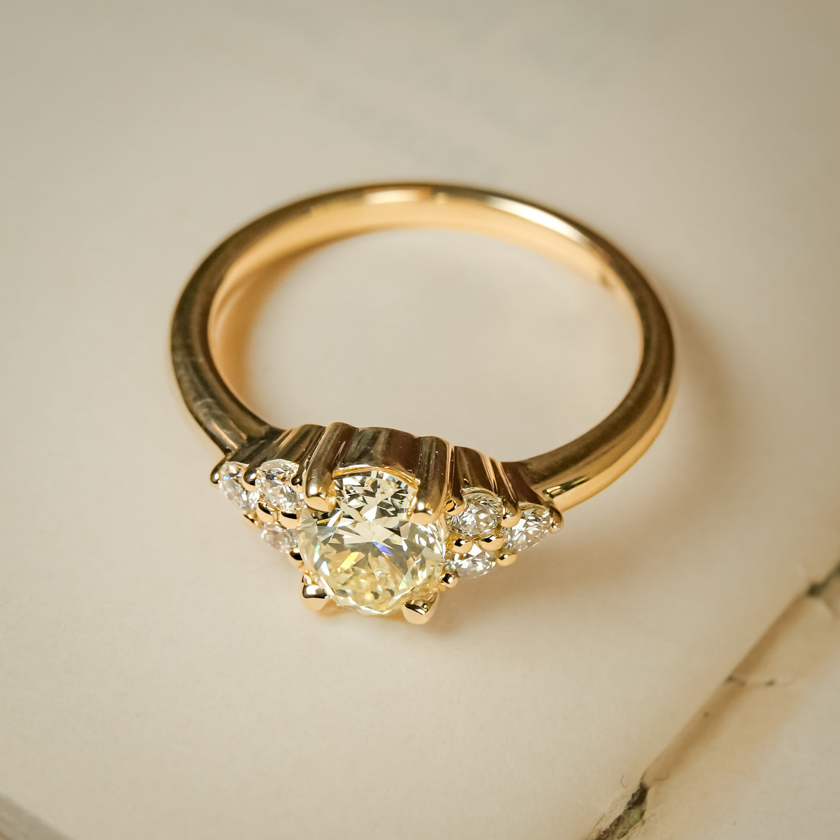 Trefoil cluster engagement ring featuring yellow diamond center stone