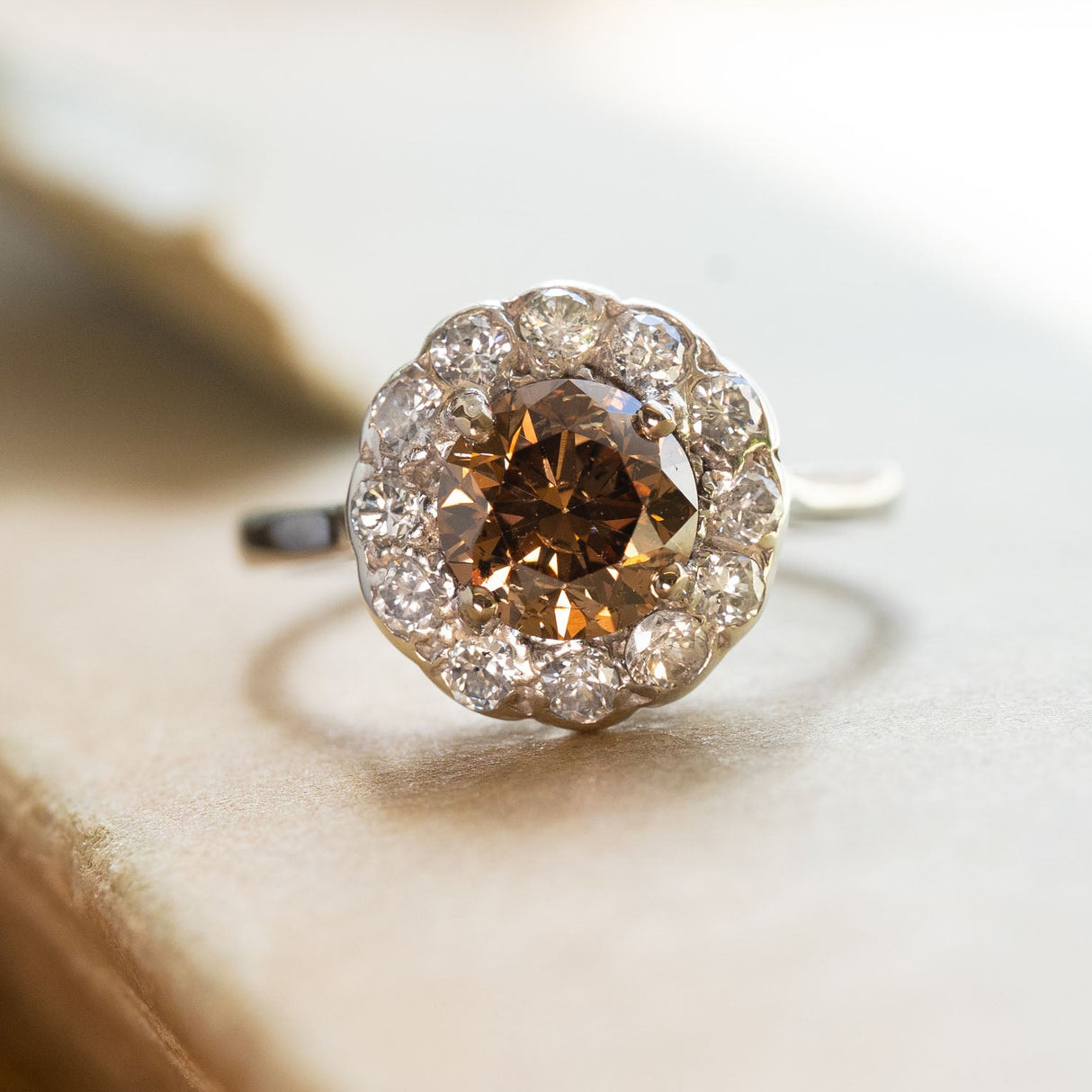 Vintage 1950s cinnamon brown diamond cluster ring with round brown diamond and diamond halo.