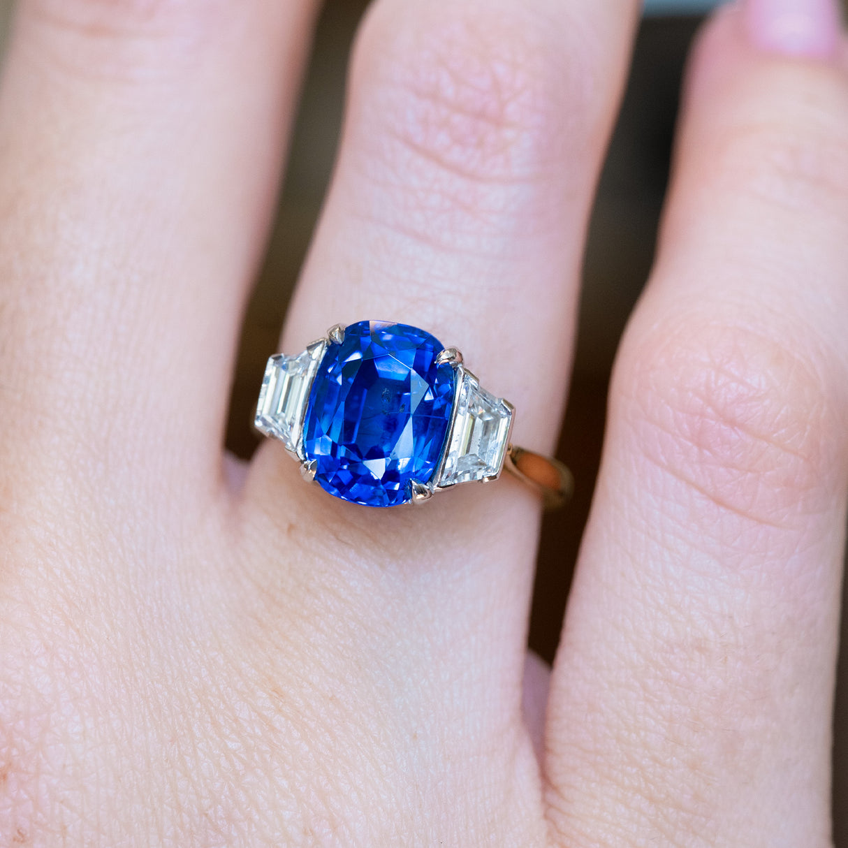 Vintage 1990s sapphire and diamond three-stone ring with oval blue sapphire and diamond side stones.