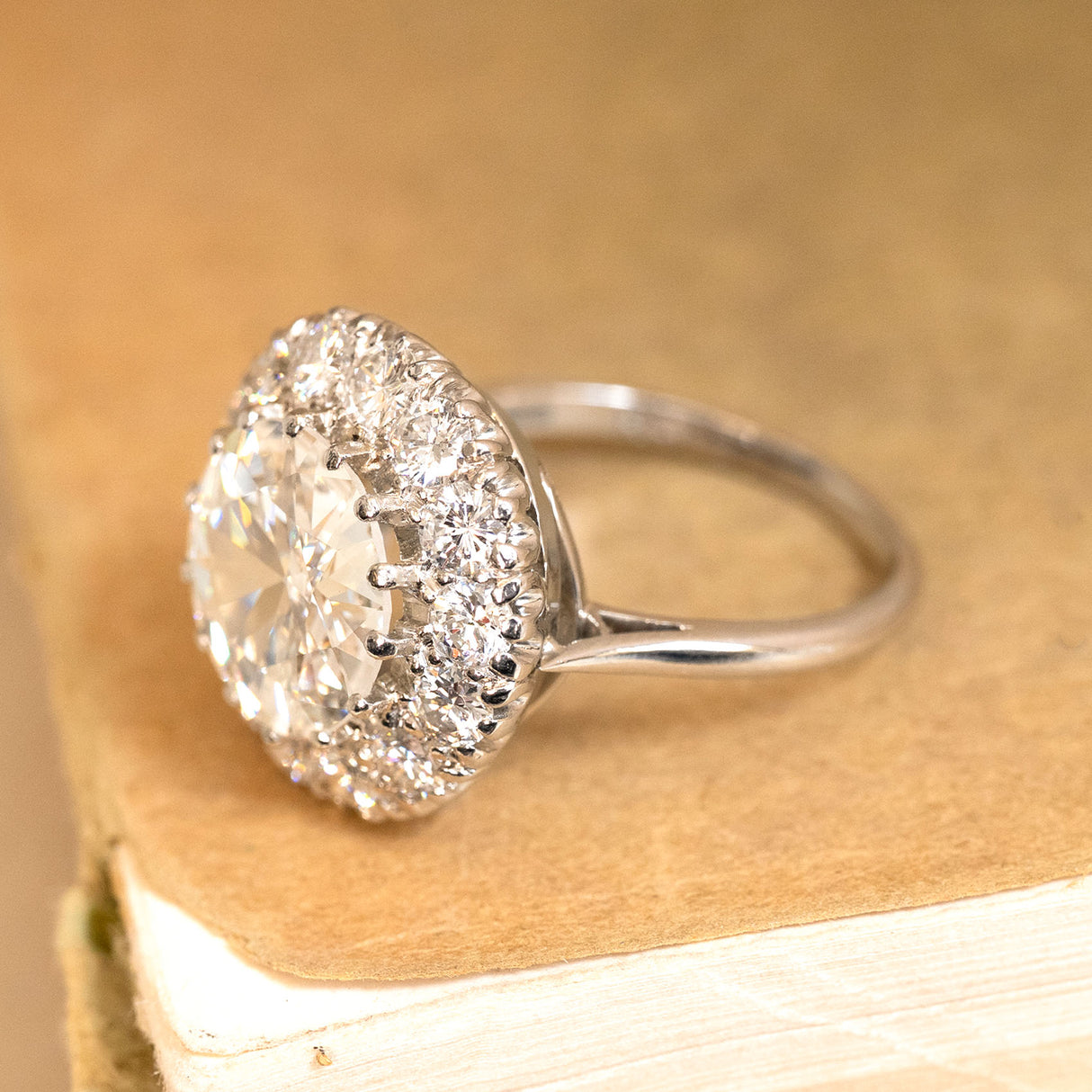 Vintage-inspired diamond cluster engagement ring showcasing a prominent old-cut diamond encircled by dazzling old-cut diamonds.