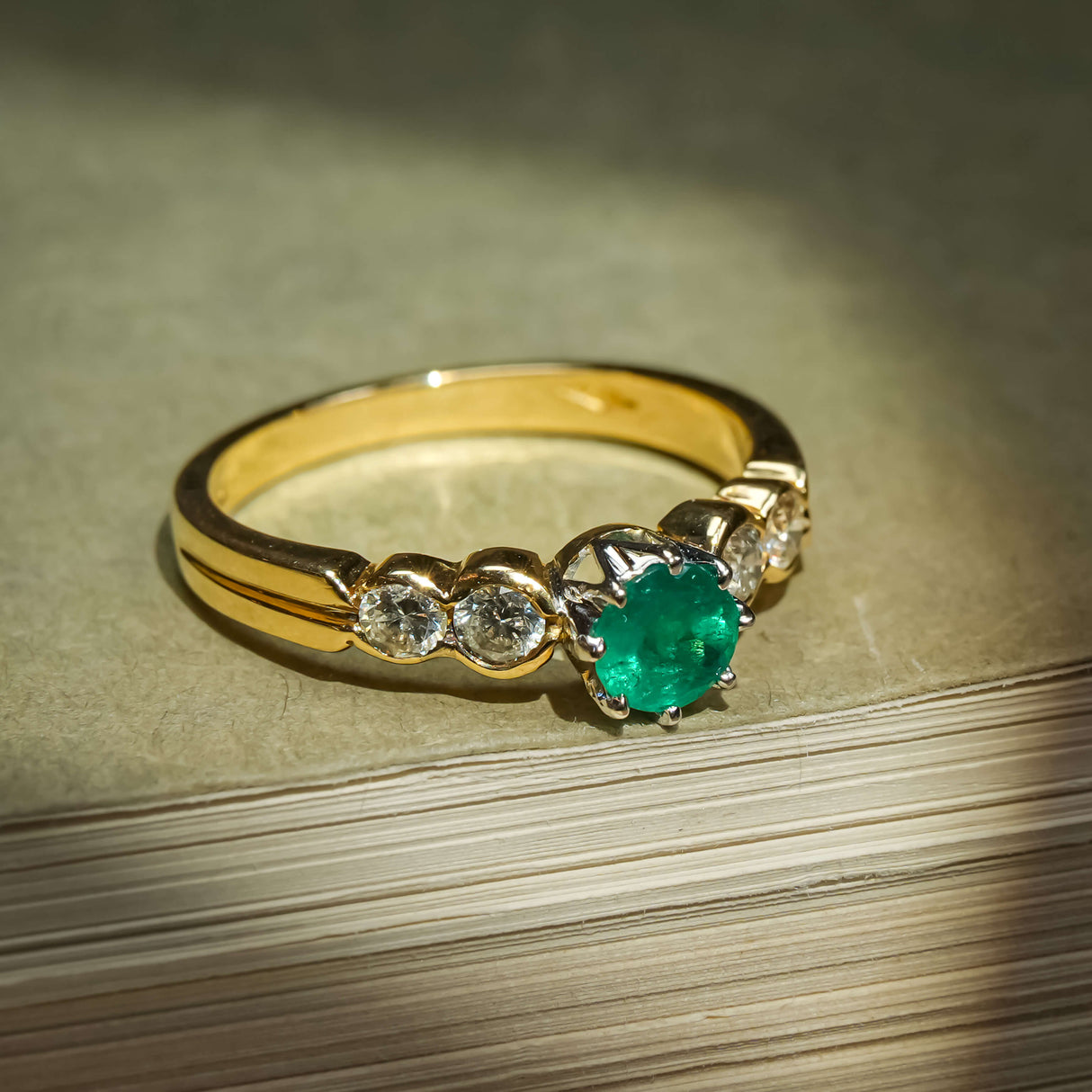 Vintage 1990s emerald and diamond five stone ring with green emerald in gold band