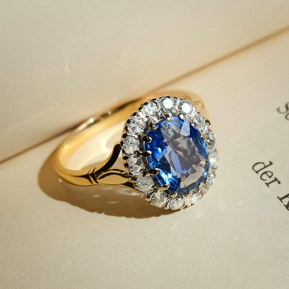 Vintage sapphire and diamond cluster ring with oval blue gemstone