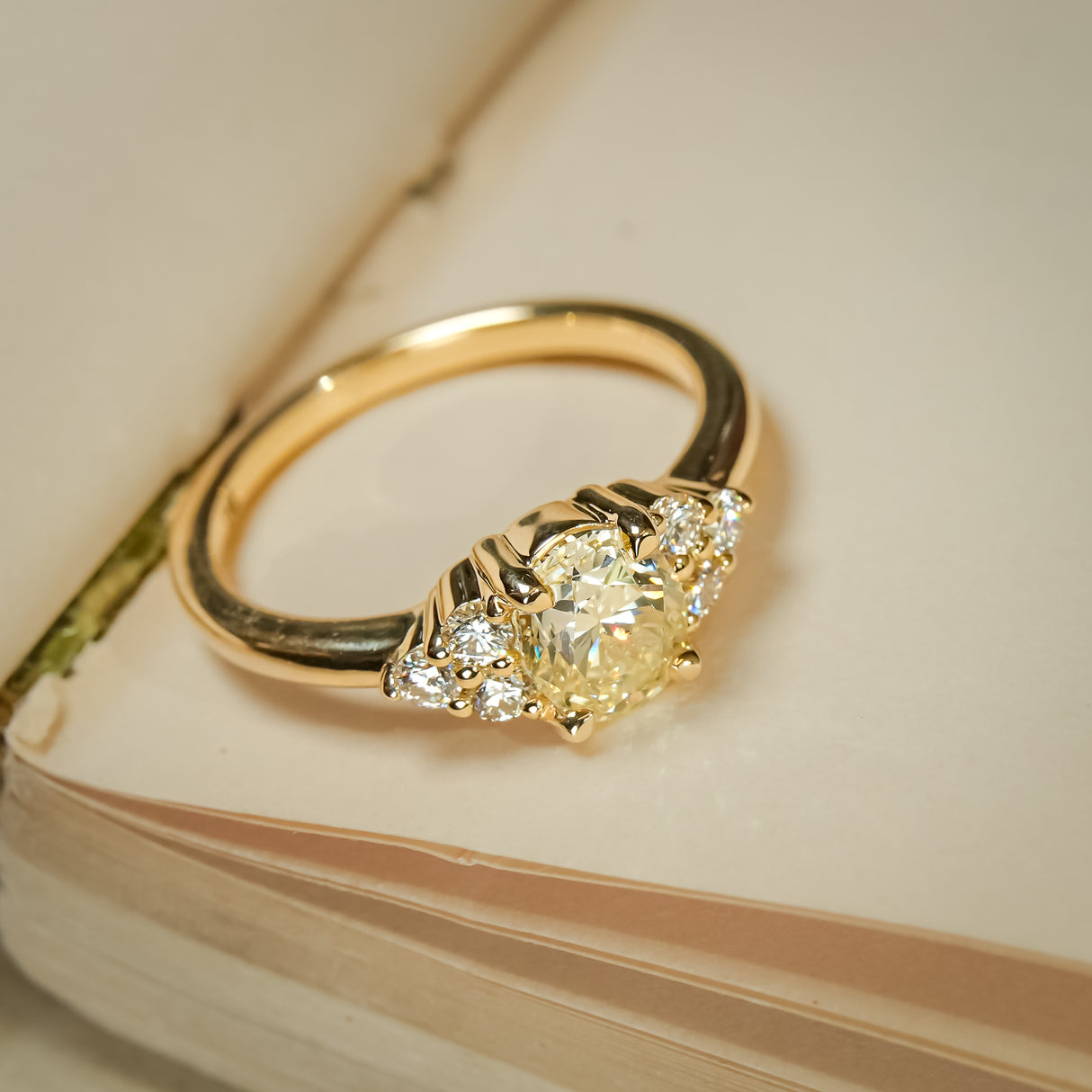 Yellow diamond cluster trefoil engagement ring set in gold