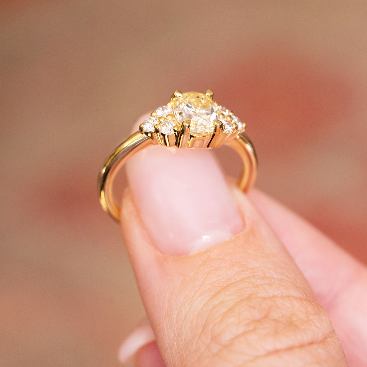 Antique-inspired primrose yellow diamond cluster tre-foil engagement ring showing raised gallery setting and gold band.