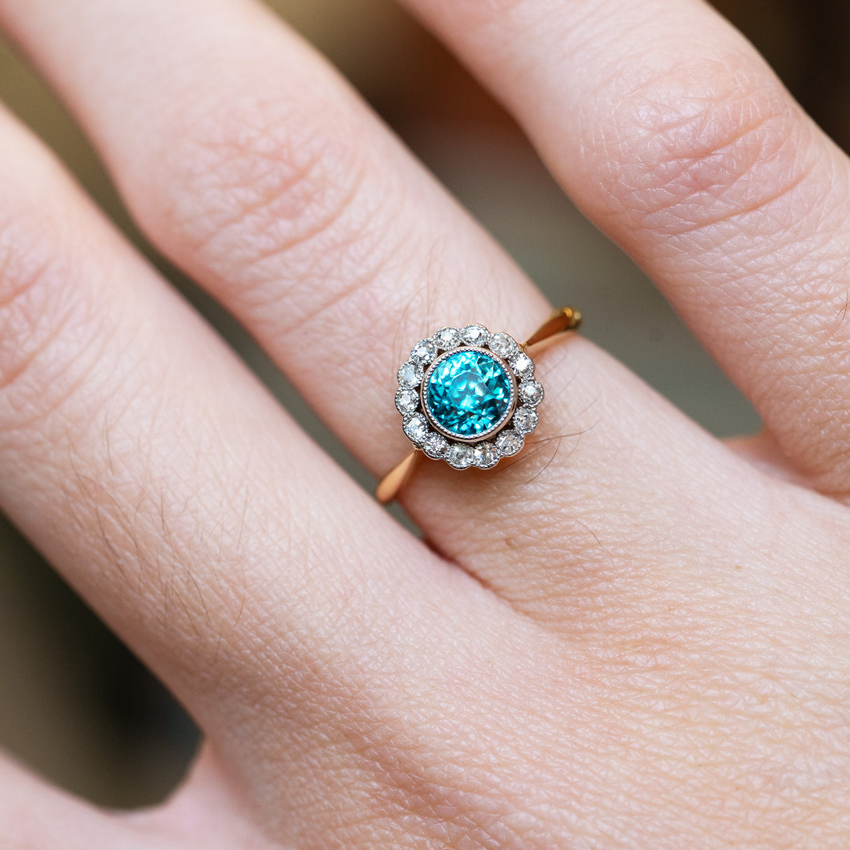 Zircon and diamond cluster ring close detail showing bright blue centre stone.