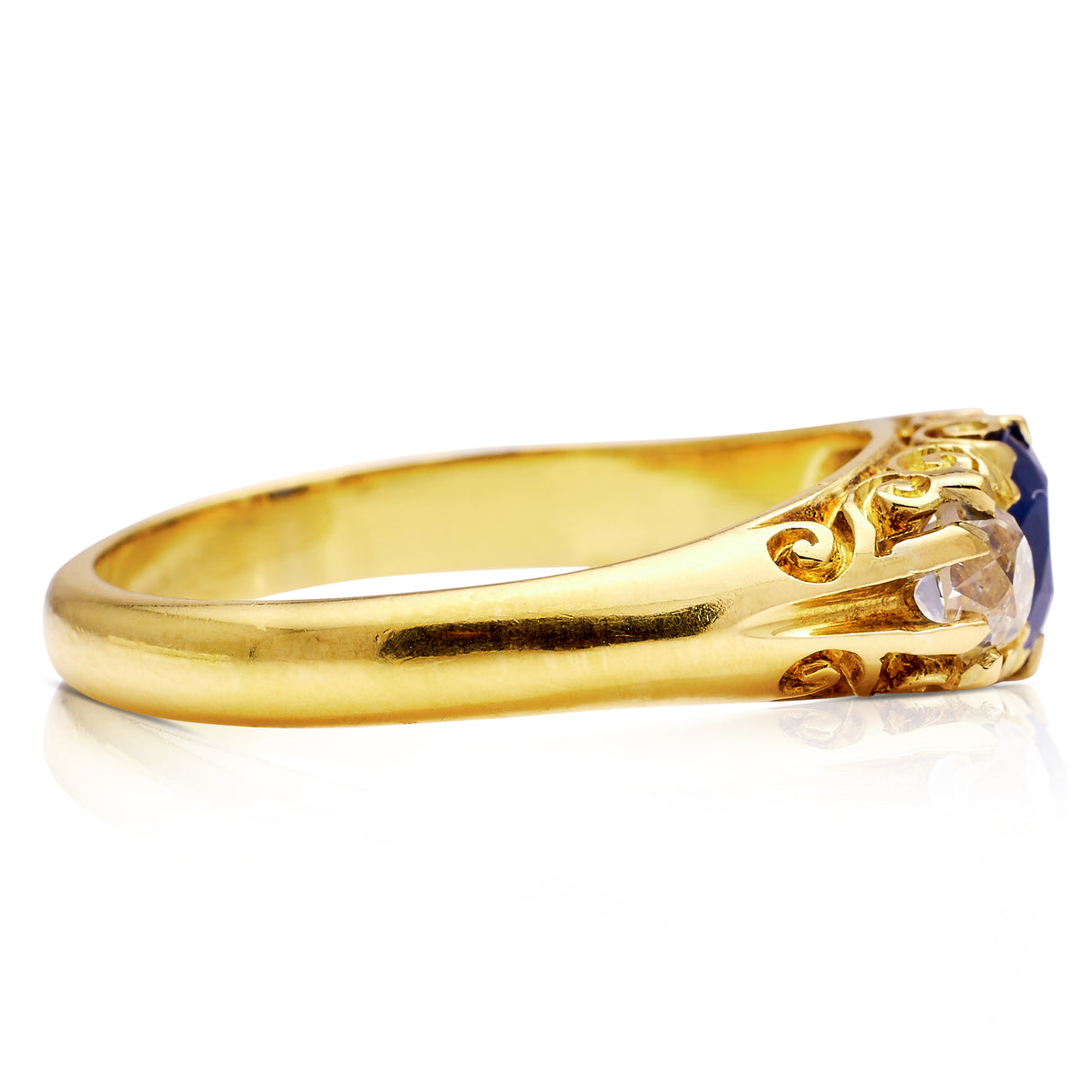 Sapphire and diamond three stone ring, side view.