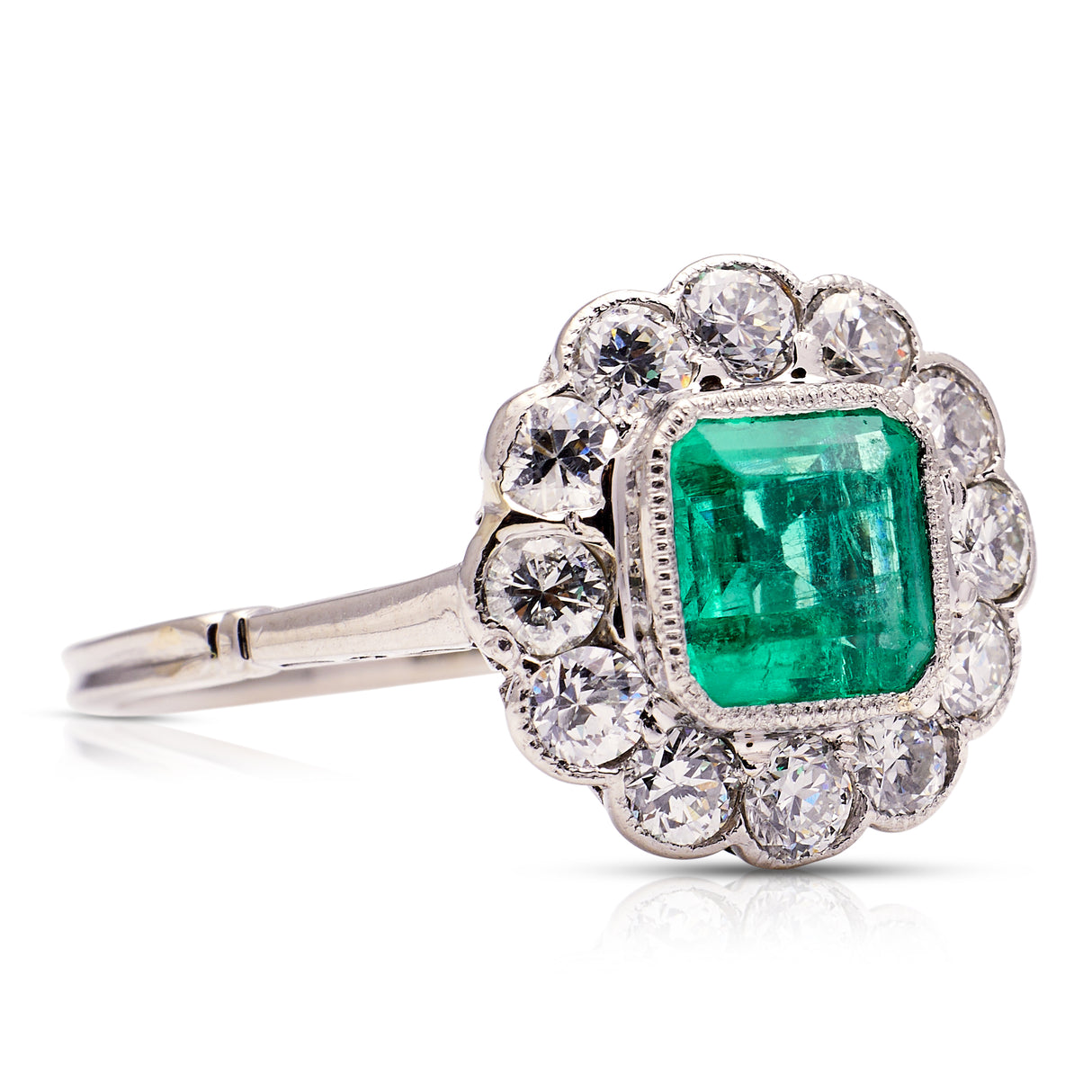 Edwardian emerald and diamond cluster ring, side view.
