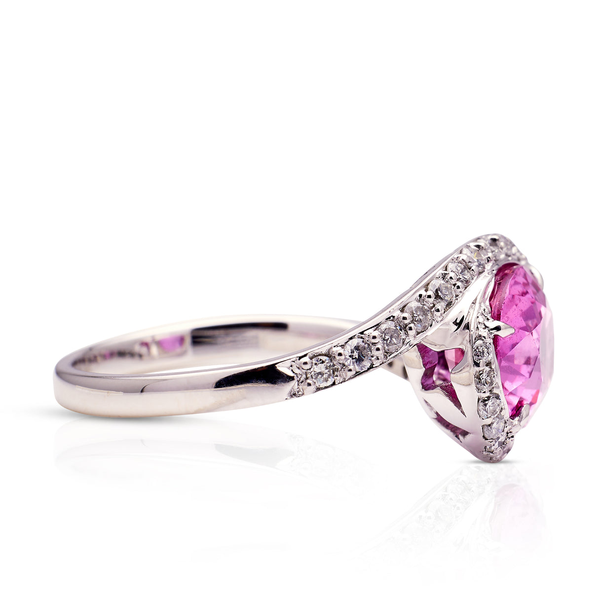 Pink sapphire and diamond engagement ring, side view.
