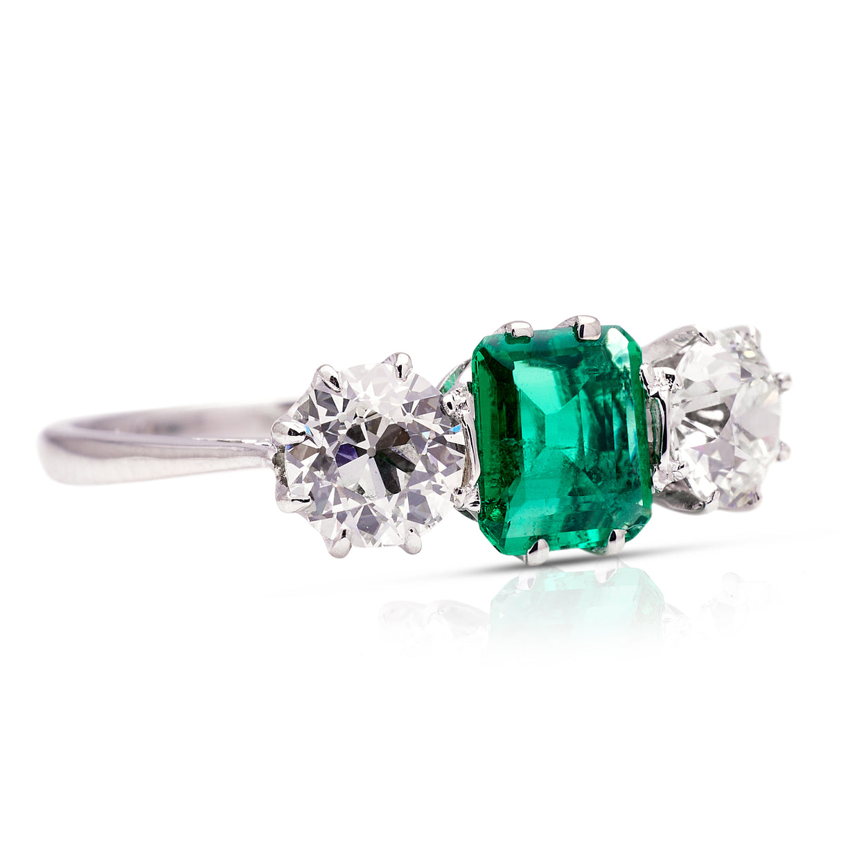Vintage Art Deco three-stone emerald and diamond engagement ring, side view.
