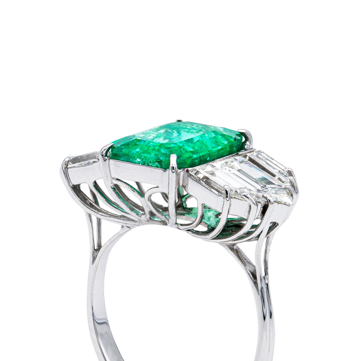 Vintage emerald and diamond engagement ring, side view.