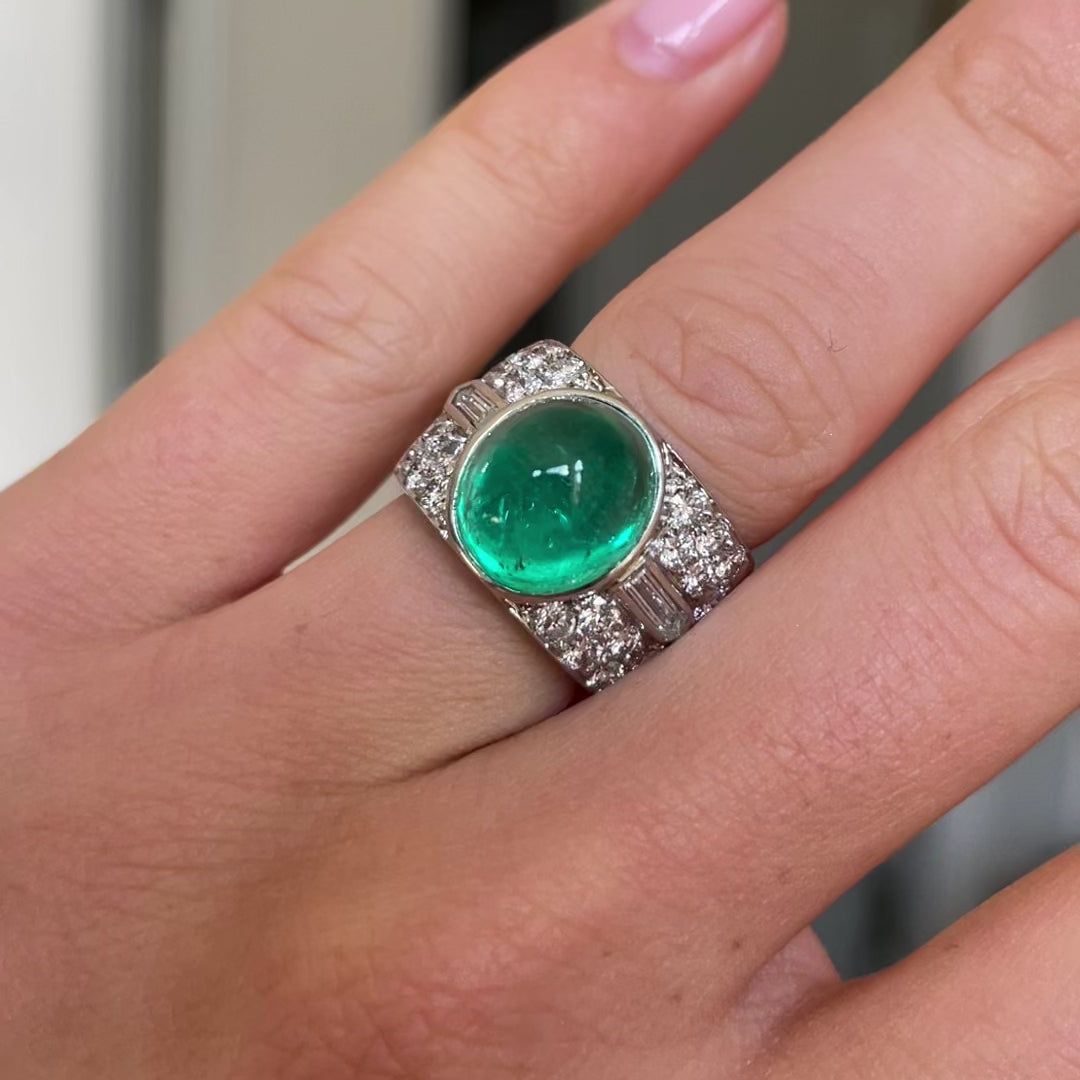 Trabert Hoeffer Mauboussin Art Deco emerald and diamond ring, worn on hand and rotated to give perspective.