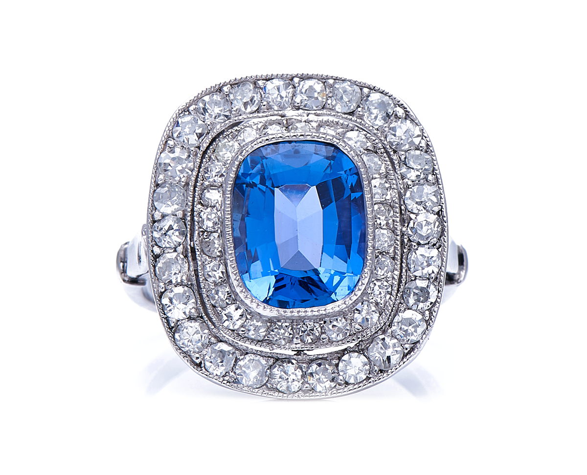 Edwardian, platinum, natural ‘cornflower’ ceylon sapphire and double row diamond cluster ring