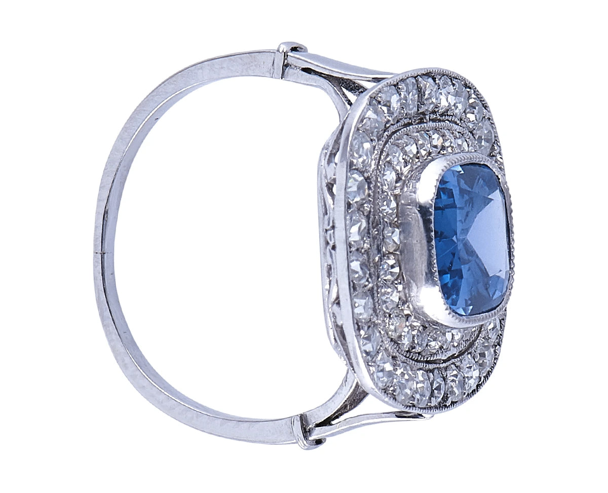 Edwardian, platinum, natural ‘cornflower’ ceylon sapphire and double row diamond cluster ring