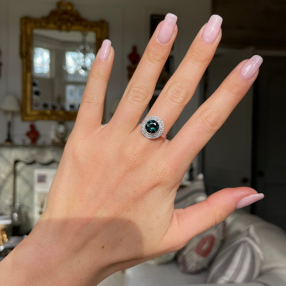 green yellow sapphire and diamond cluster ring, worn on hand.