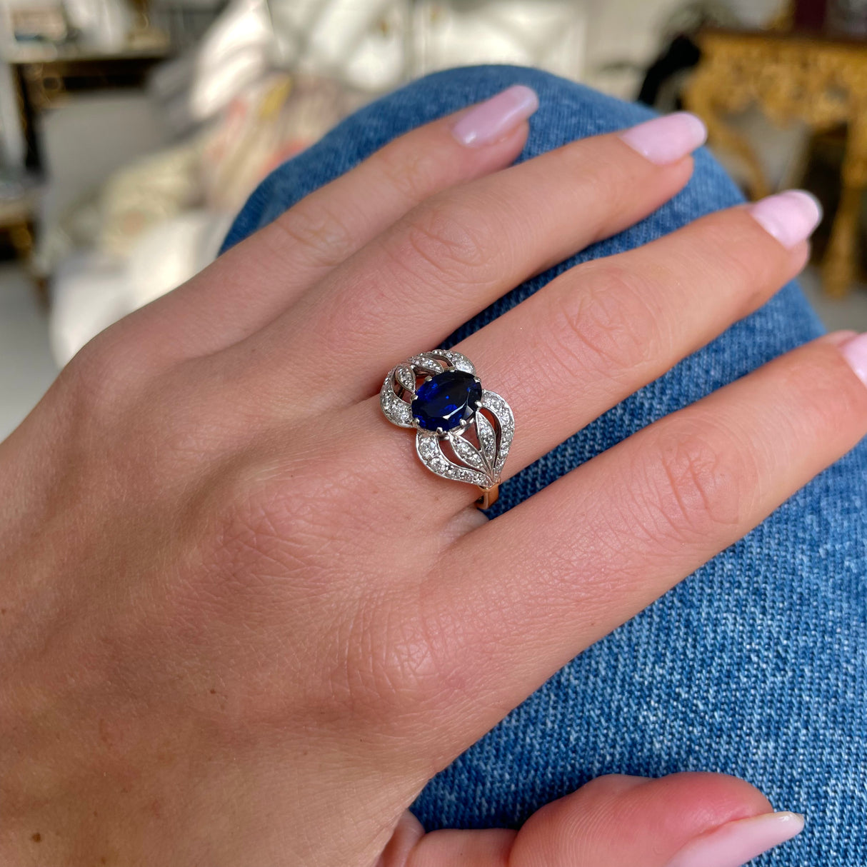 Art Nouveau, sapphire and diamond ring, worn on hand.