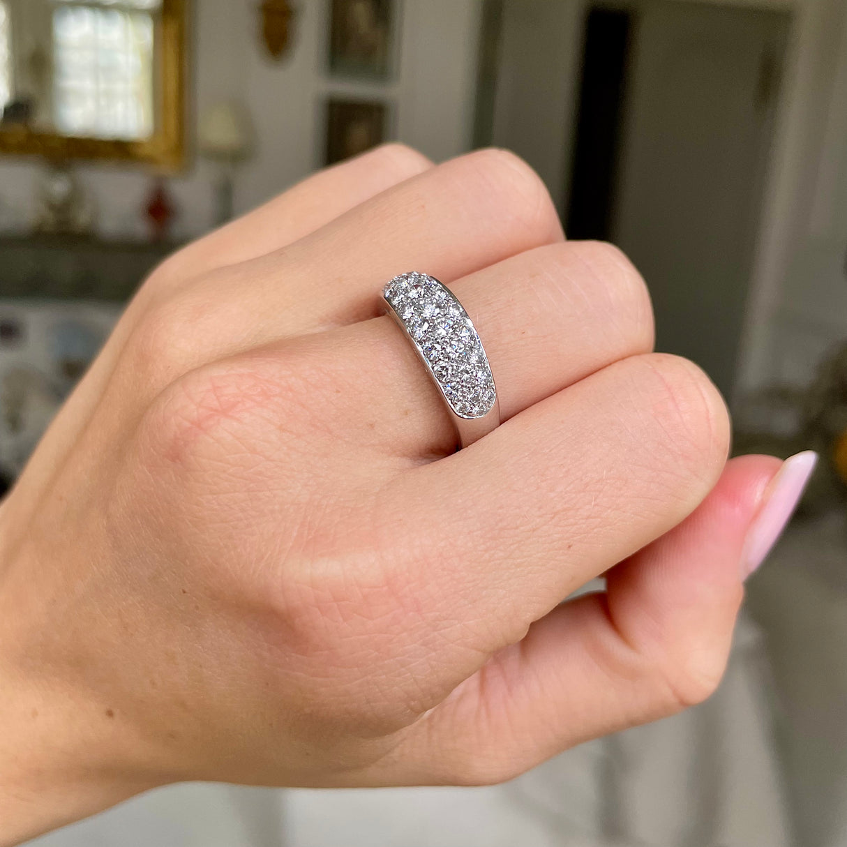 diamond- set platinum band worn on closed hand.