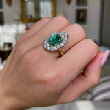 Emerald and diamond navette ring,  worn on hand.