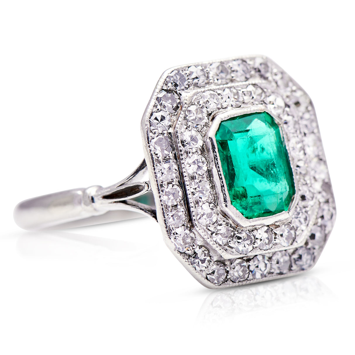 Vintage emerald and diamond cluster ring, side view.