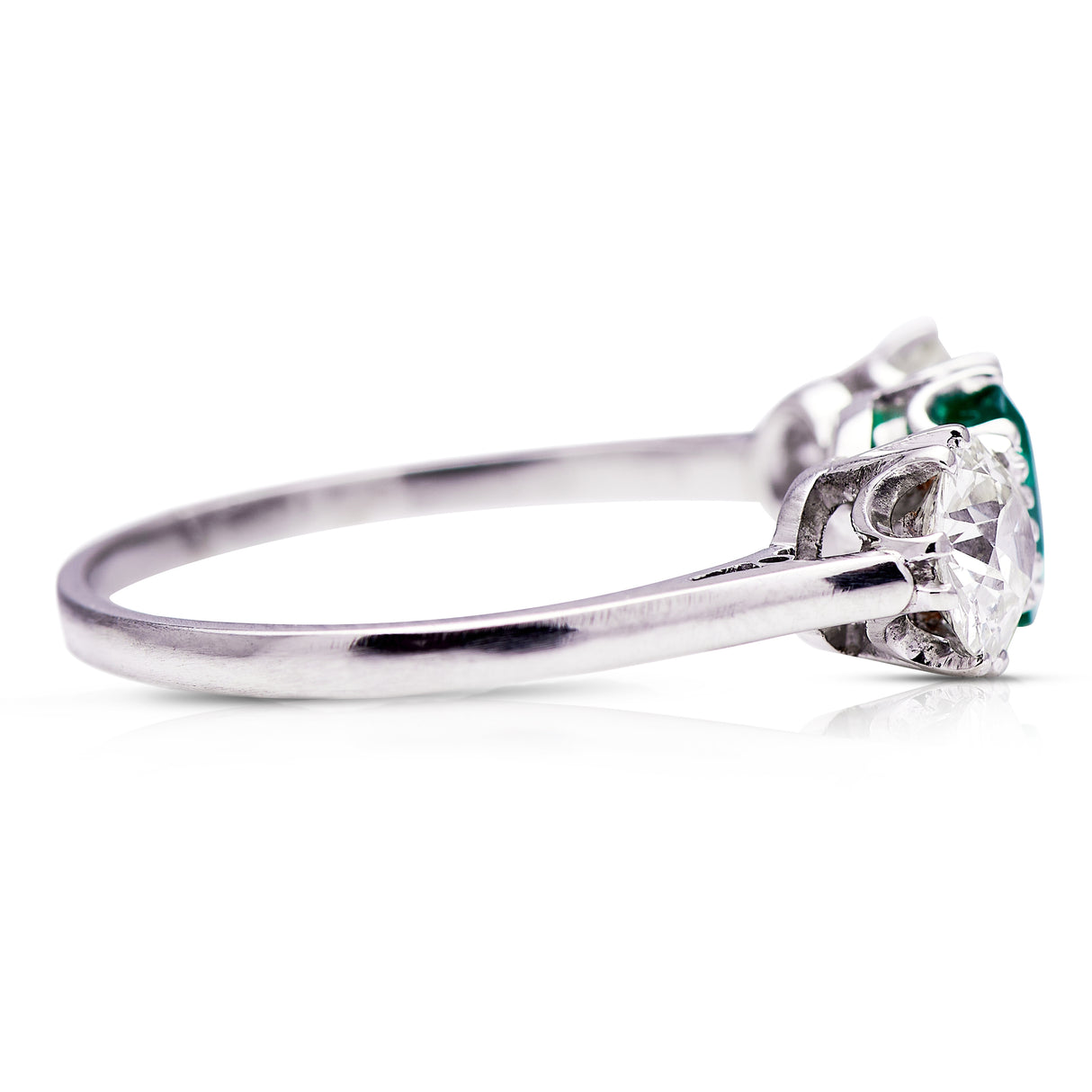 three stone, platinum, diamond and emerald ring - side view