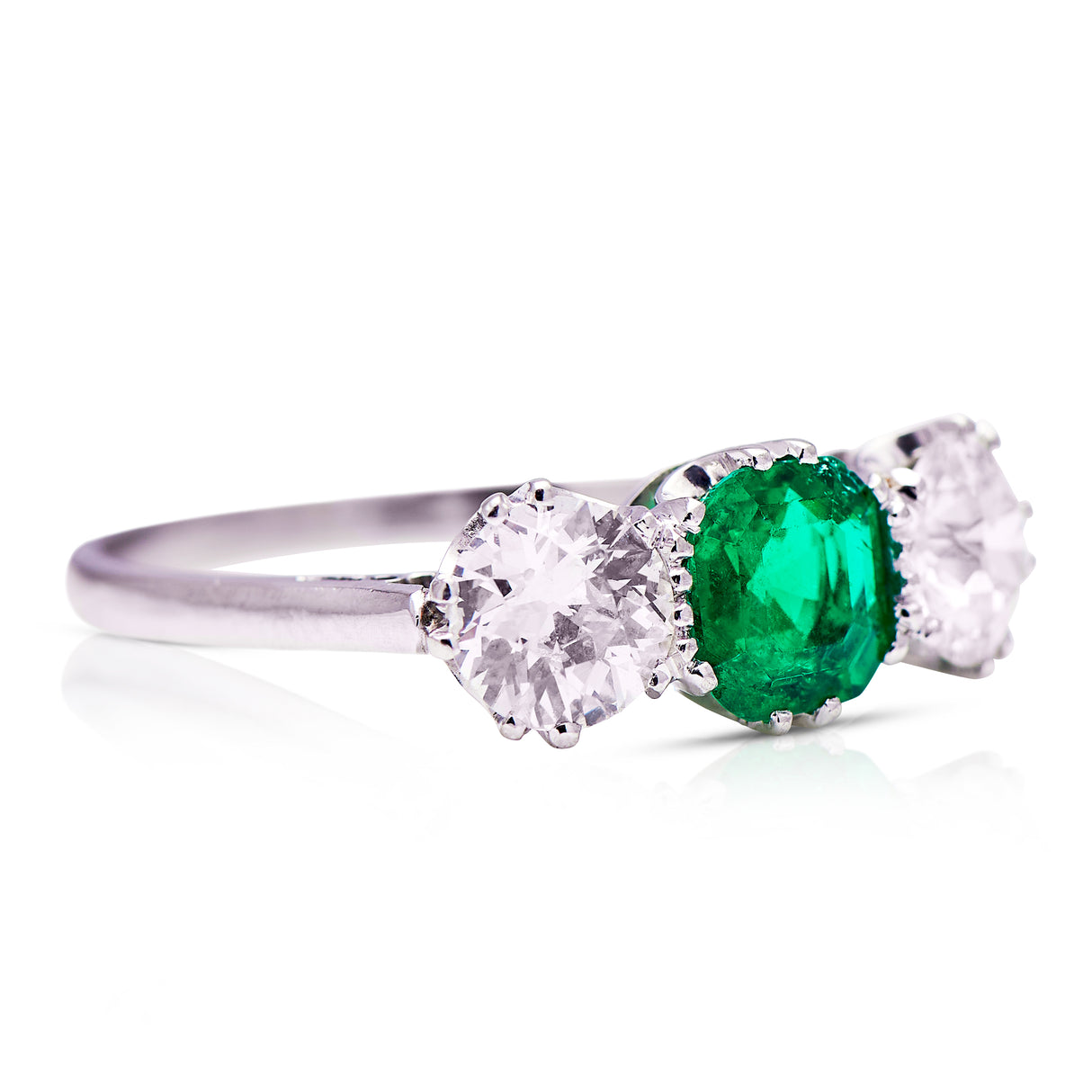 three stone, platinum, diamond and emerald ring - front side view