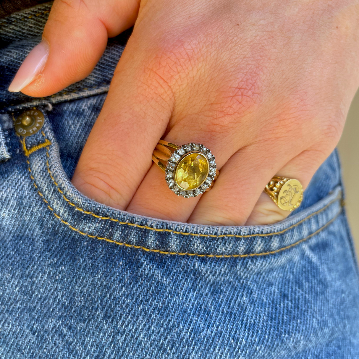 Antique Georgian citrine and diamond cluster ring, worn on hand.